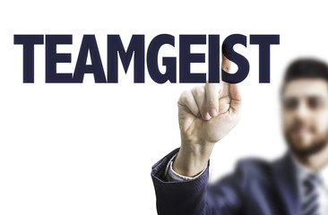 Business man pointing the text: Team Spirit (in German)