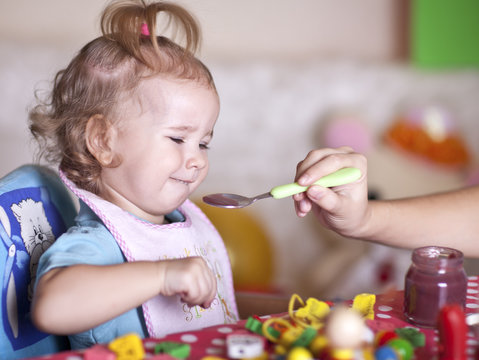 Child Refuses To Eat. A Baby Is Fed With A Spoon At Home