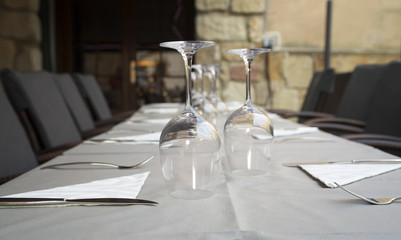 Served table in a restaurant with white tablecloth and wineglasses