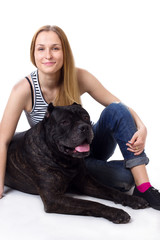 girl sitting next to his dog Cane Corso