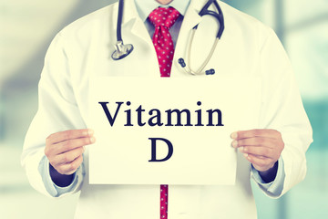 doctor hands holding white card sign with vitamin D text message