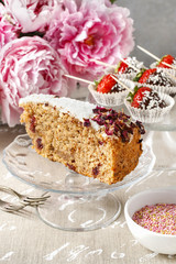 Carrot vegan cake with coconut icing and dried wild rose petals