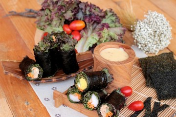 Obraz na płótnie Canvas Vegetable salad wrapped with seaweed into spring rolls.