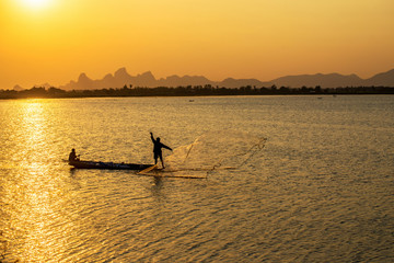 fisherman throw a net to catch a fish