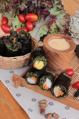 Fototapeta na wymiar Vegetable salad wrapped with seaweed into spring rolls.