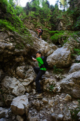Obraz premium Group of hikers with backpacks on difficult trail