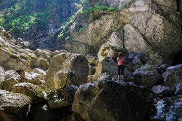 Woman tourist photographing a cave