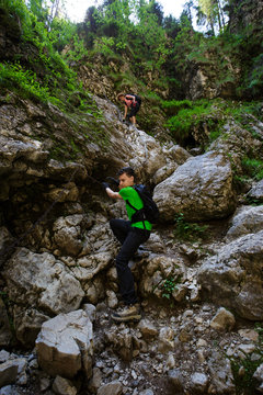 Group of hikers with backpacks on difficult trail