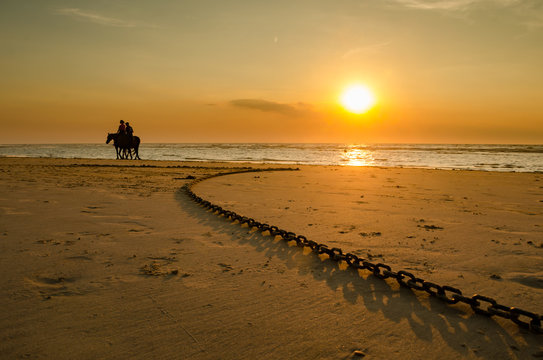 zonsondergang met ruiters op het Belgische strand