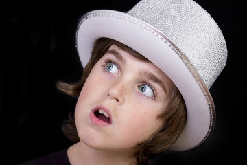 portrait of a young boy with big blue eyes with his white hat