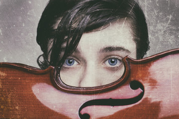 Beautiful blue-eyed boy holding a violin