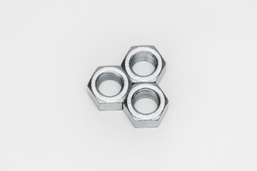 Arranged metal nuts on white background