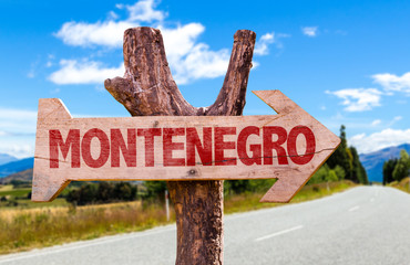 Montenegro wooden sign with road background