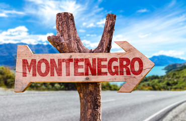 Montenegro wooden sign with road background
