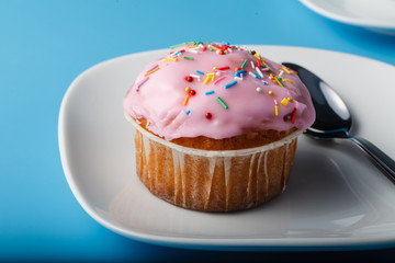 Colorful muffin on saucer