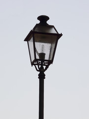 Fototapeta na wymiar An ornate street lamp made of wrought iron.