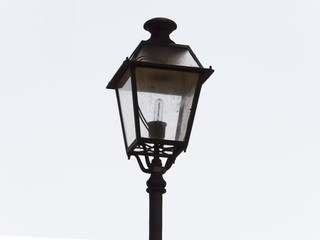An ornate street lamp made of wrought iron.
