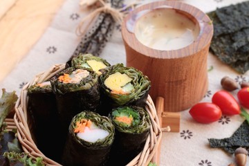 Vegetable salad wrapped with seaweed into spring rolls.