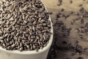 Flax seeds linseed in bowl on wooden table