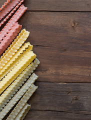 Tricolor mafalde pasta on the wood