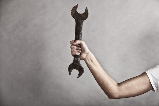 Wrench spanner tool in hand of female worker