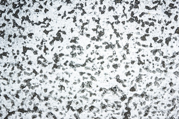 Grunge cracked white paint asphalt texture.