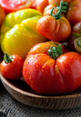 assorted tomatoes on wooden surface