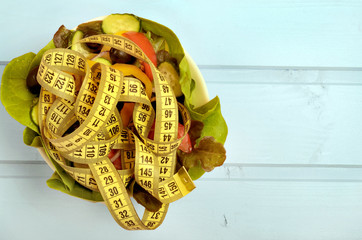 Bowl with vegetable salad and centimeter