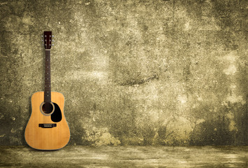 Naklejka na ściany i meble Acoustic guitar against old wall