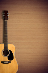 Acoustic guitar on wooden background