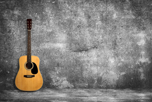 Acoustic guitar against old wall © christianchan