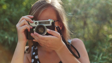 Girl taking pictures with vintage camera
