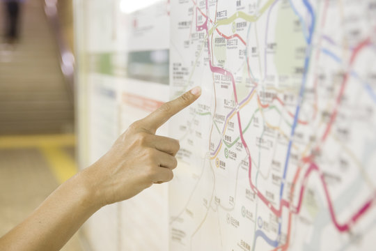 A tourist pointing the touritst attraction on a map public