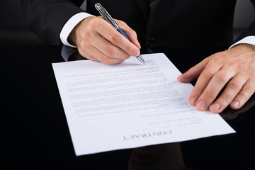 Businessperson Signing Contract Paper