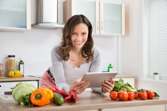 Woman With Digital Tablet And Vegetables