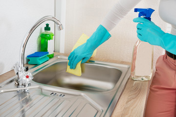 Woman Wiping Kitchen Sink