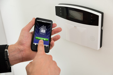 Businessperson Arming Security System