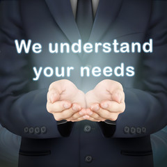 businessman holding we understand your needs words