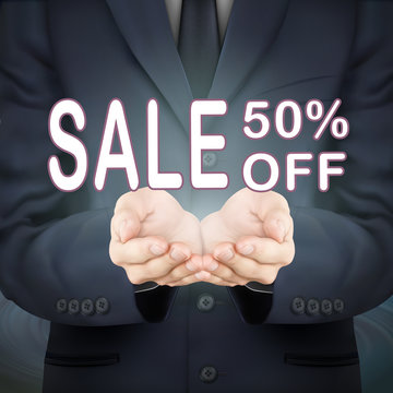 businessman holding sale 50 percent off words
