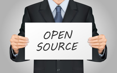 businessman holding open source poster