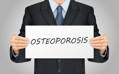 businessman holding osteoporosis poster