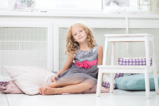 Young girl sitting on the floor of her room