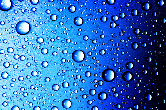 Water drops closeup. Abstract blue background of waterdrops