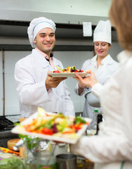 Chefs and young waiter