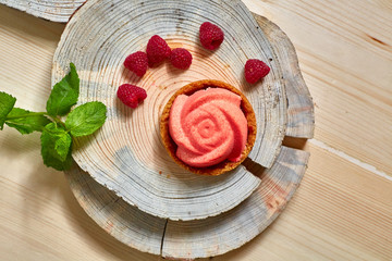 Home made tartlet rose on wooden background.