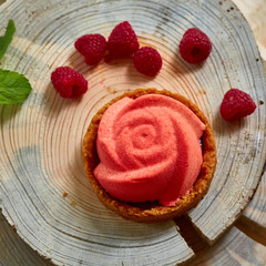 Home made tartlet rose on wooden background.
