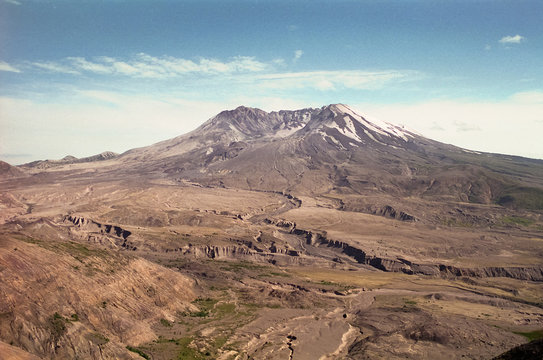 Mount Saint Helens in 1997 - Mt. St. Helens lit by setting sun in the evening. The volcano, crater, dome and lava flow (post May 18, 1980 eruption) can be seen. Grainy photo shot in July 1997 on film.