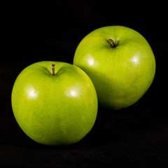 Green apple on black background