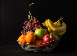 Composition with assorted fruits in  big bowl isolated on white