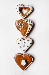 Row of christmas gingerbread heart-shaped on white background